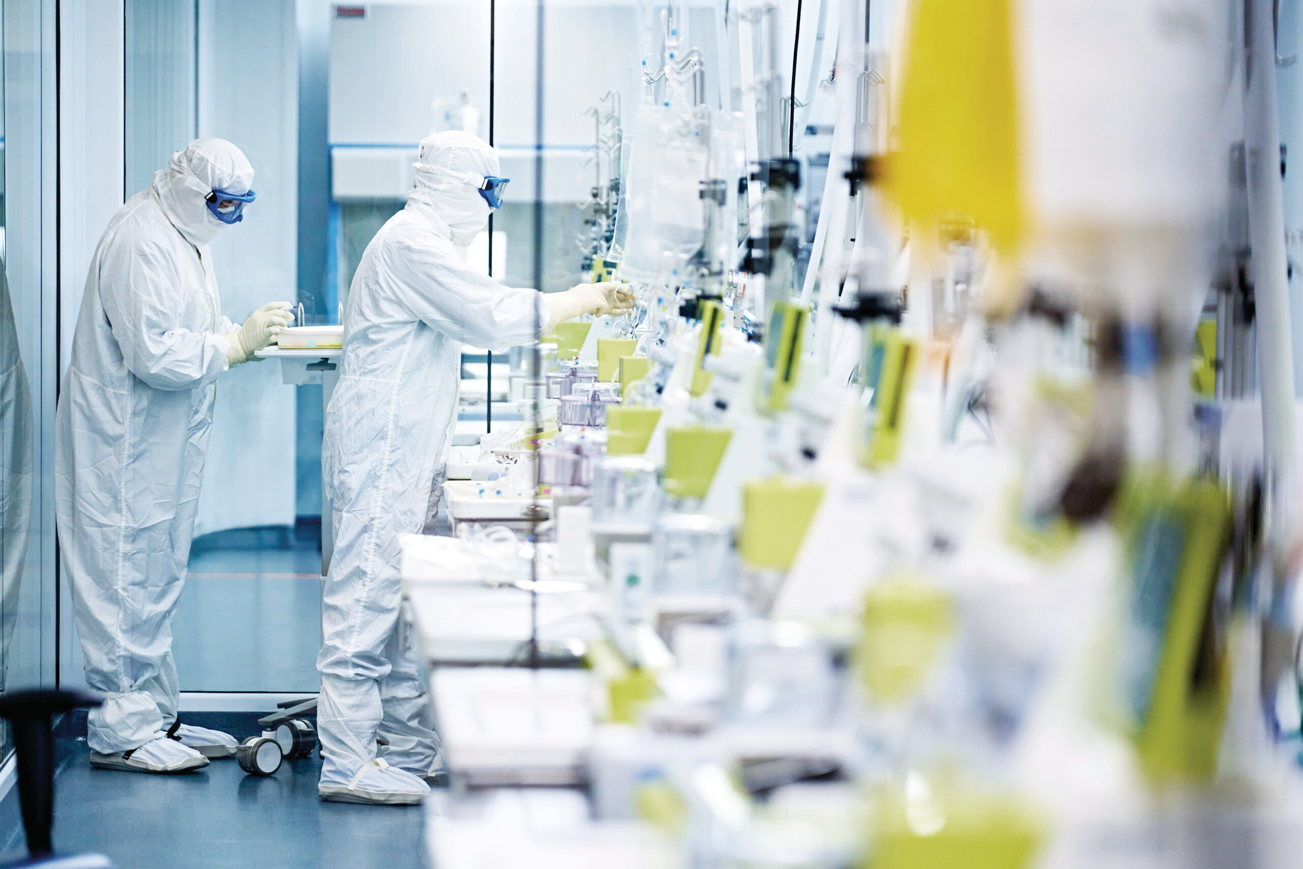 Two people working in a clean room on different CliniMACS Prodigies.