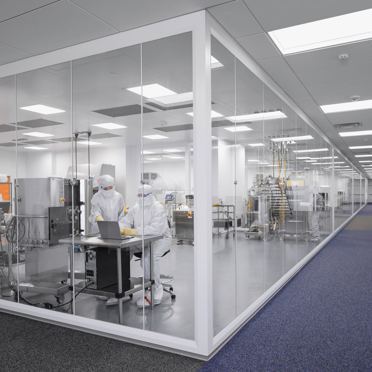 View from the outside into a manned clean room with bioproduction.