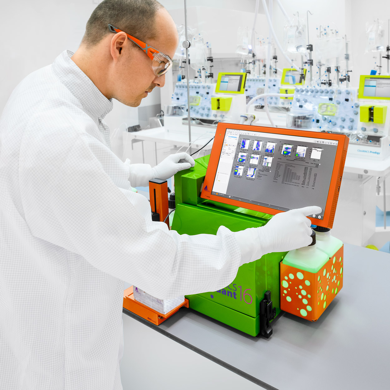 Male in lab attire working on a MACSQuant Analyzer 16.